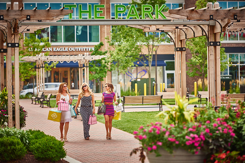 Three women walking through The Park at Liberty