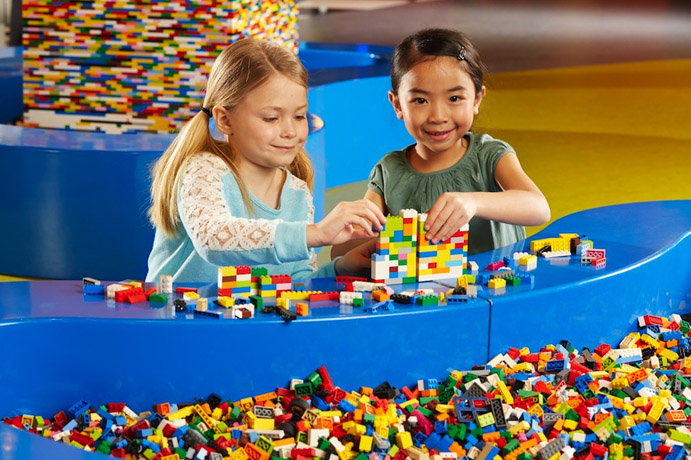 Two young girls playing with Legos at Legoland