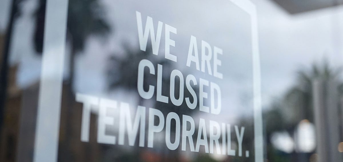 Window decal that says "We are closed temporarily"