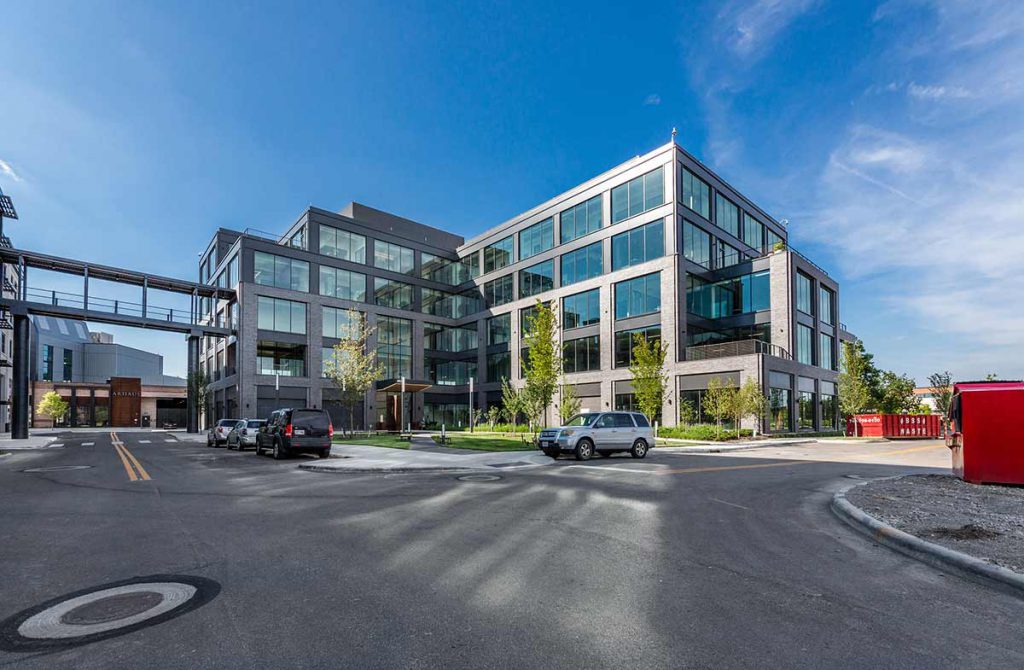 Multi-story office building under bright blue sky